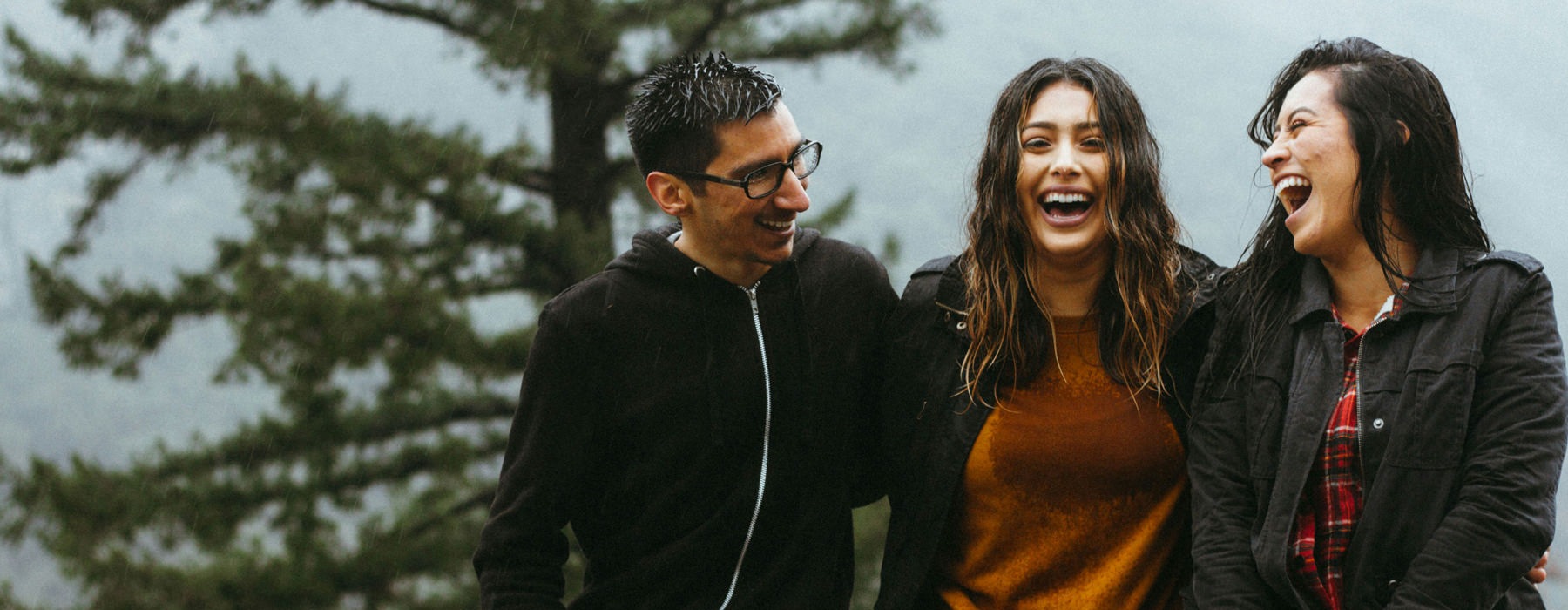 people laughing in the rain
